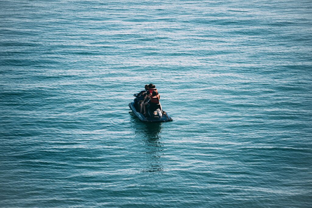 folks on a jet ski in a body of water