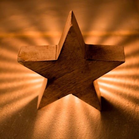 a photo of a wooden star shining