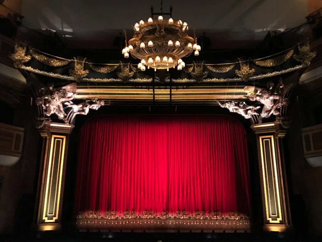 Theatre stage with long red curtains
