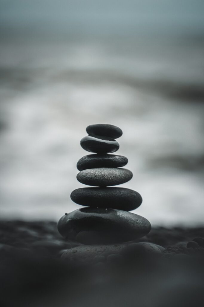 stones stacked on top of each other in the sand 