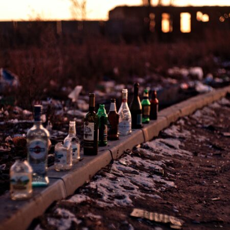 empty liquor bottles on curb